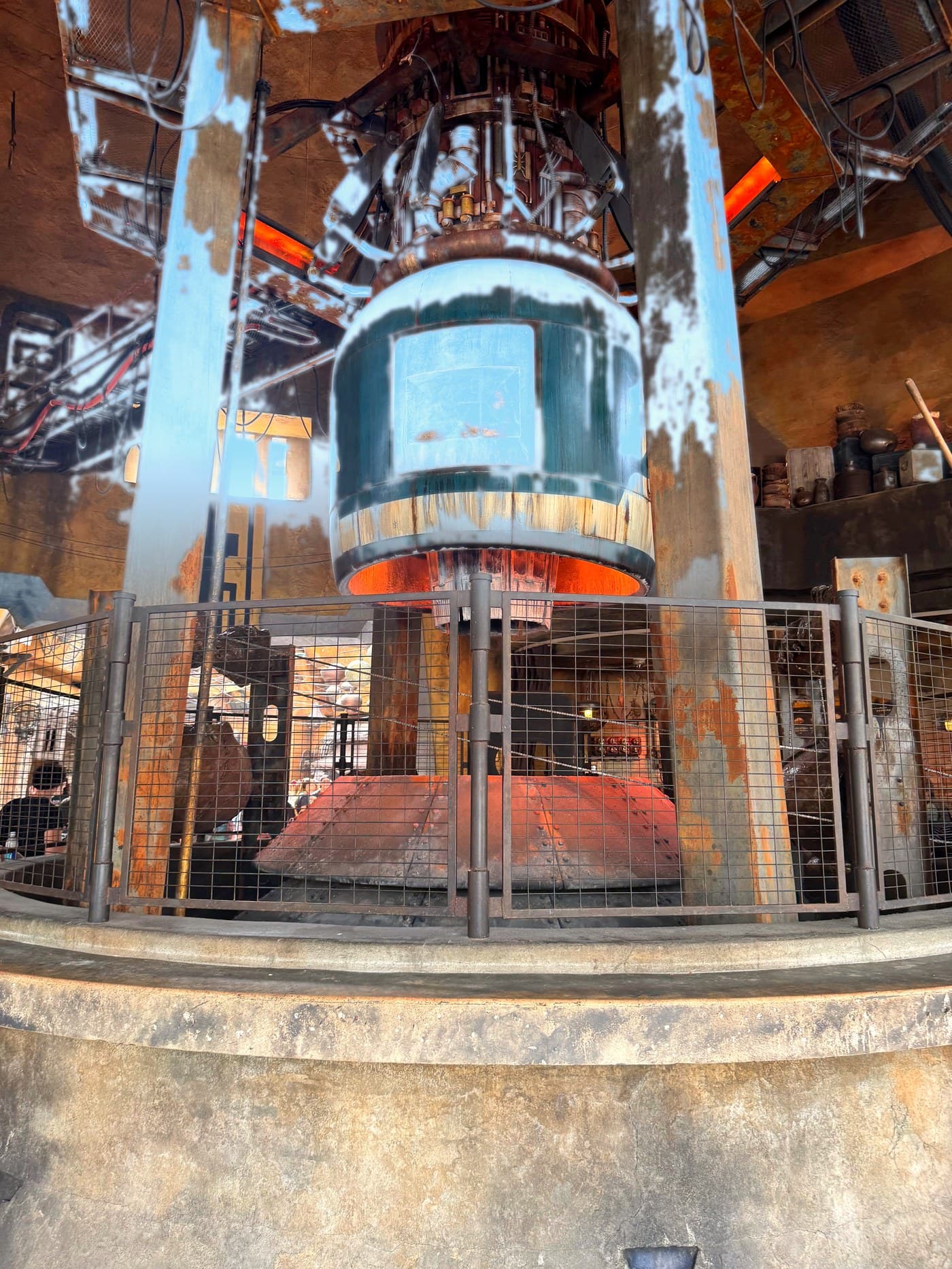 Freshly roasted meat-and-spice wraps on a heated rotating spit at Ronto Roasters in Star Wars: Galaxy's Edge at Disney's Hollywood Studios, the filling sizzling and caramelizing under the heat — a nod to the in-universe Spit-Roasted Rontos of Black Spire Outpost.