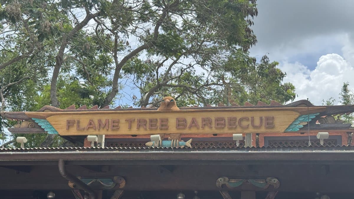 Flame Tree Barbecue at Disney's Animal Kingdom — an open-air quick-service barbecue restaurant on Discovery Island with waterfront seating overlooking the park's central lagoon and views of Expedition Everest.